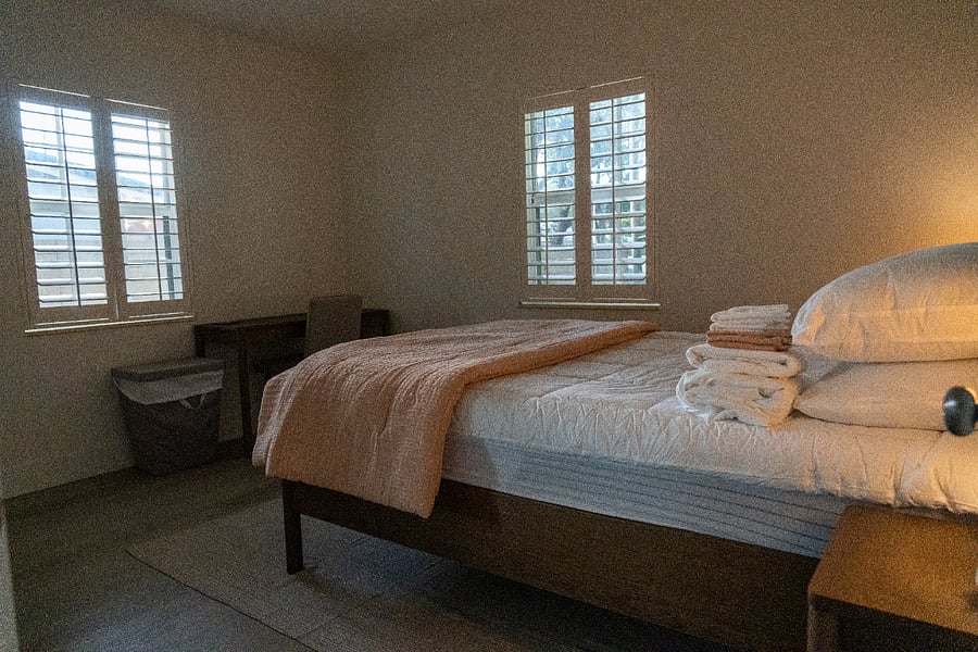 Secondary bedroom towards the back with a desk and a desk chair.