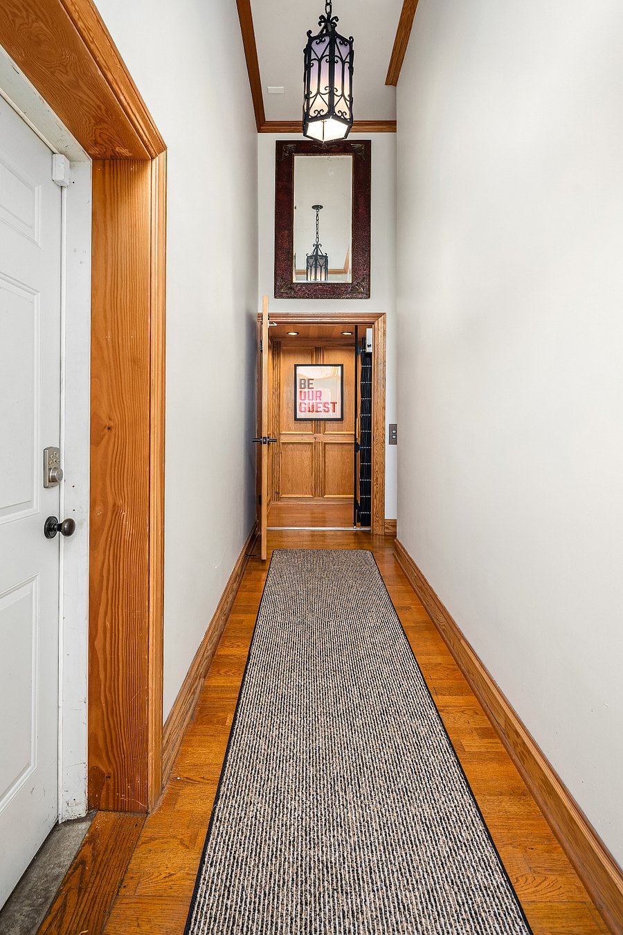 Garage people door on left enters into entry hall to apartment elevator.