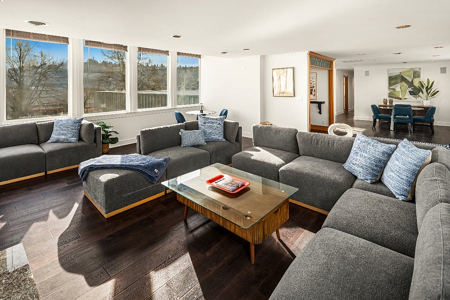 Lots of natural light floods the living room. There is lots of seating and a bistro table to use as a desk or dining.