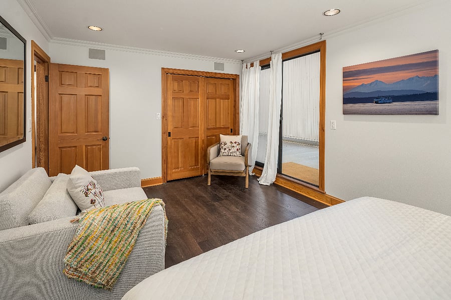 The second bedroom has a slider which opens onto a deck area with access to a stairway to the secured entry court.