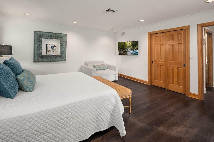 Primary room has a California King bed, a twin sleeper chair, a TV and bathroom ensuite.