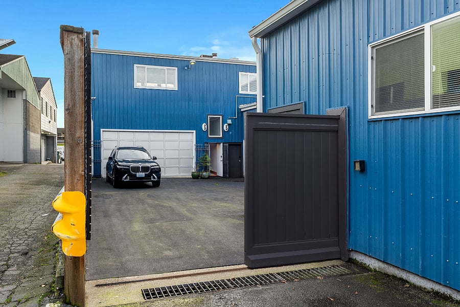A rolling gate secures the private courtyard and access to the garage and apartment.