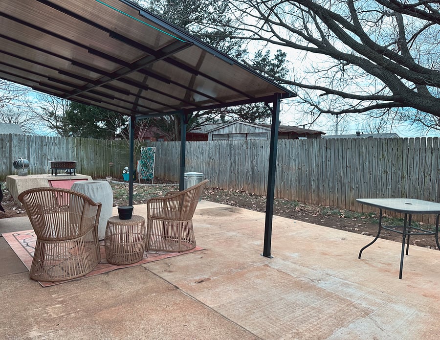 Covered back patio with seating, gas fire pit and storm shelter. 