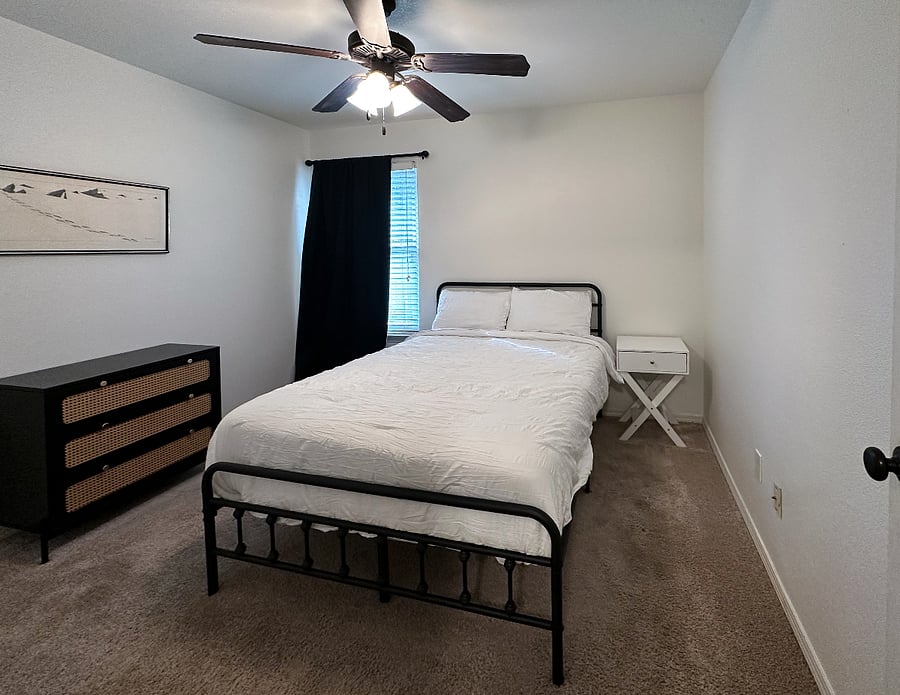 Back bedroom with brand new full size bed and bedding and a closet, along with dresser for extra storage. 