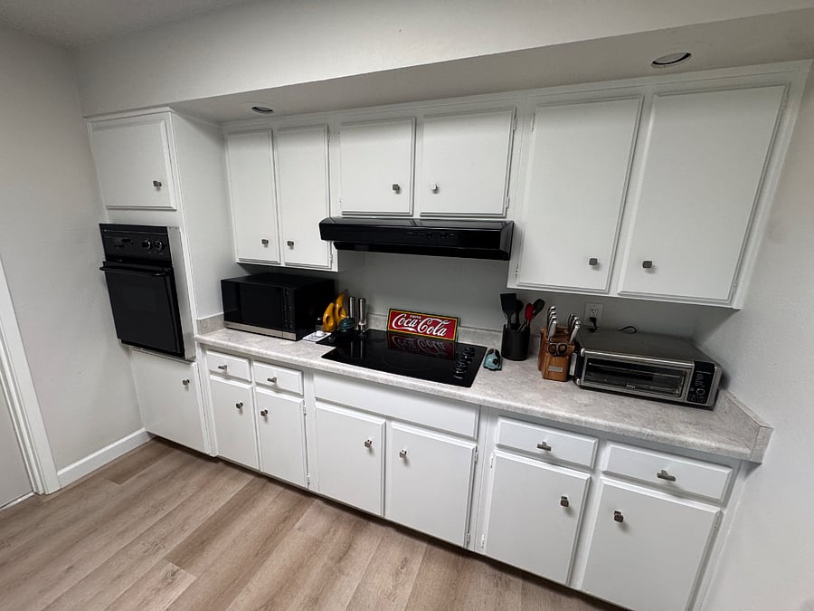 Kitchen. Photo shows oven, microwave, toaster oven/air fryer combo.