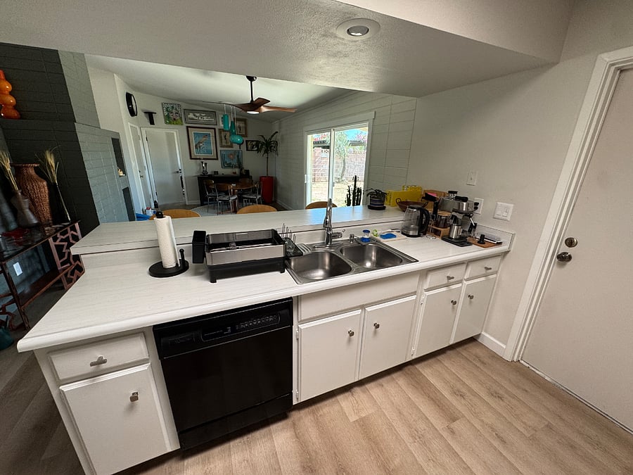 Kitchen. Photo shows sink, dishwasher, espresso/coffee station.