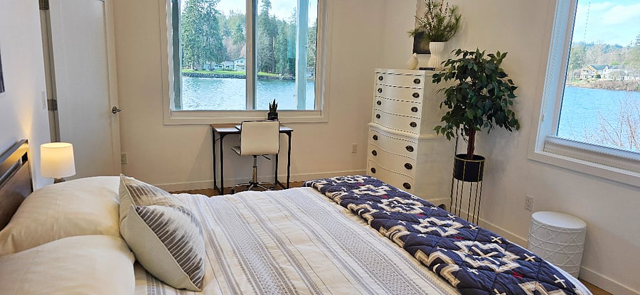 Bedroom with water view. Has shades that cover all of windows.