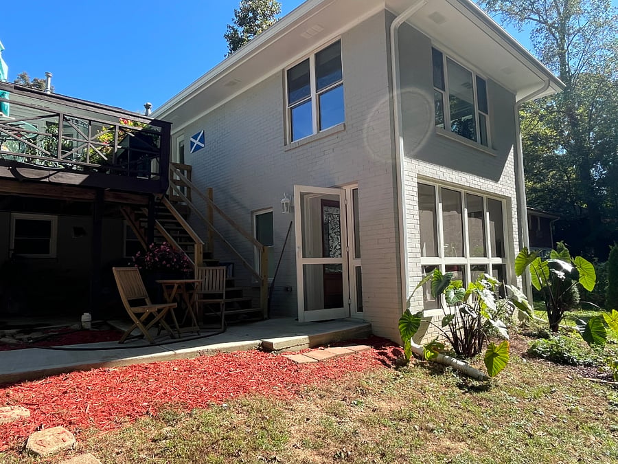Personal front door into screened in porch on the apartment. The garden has multiple seating areas that can be used.