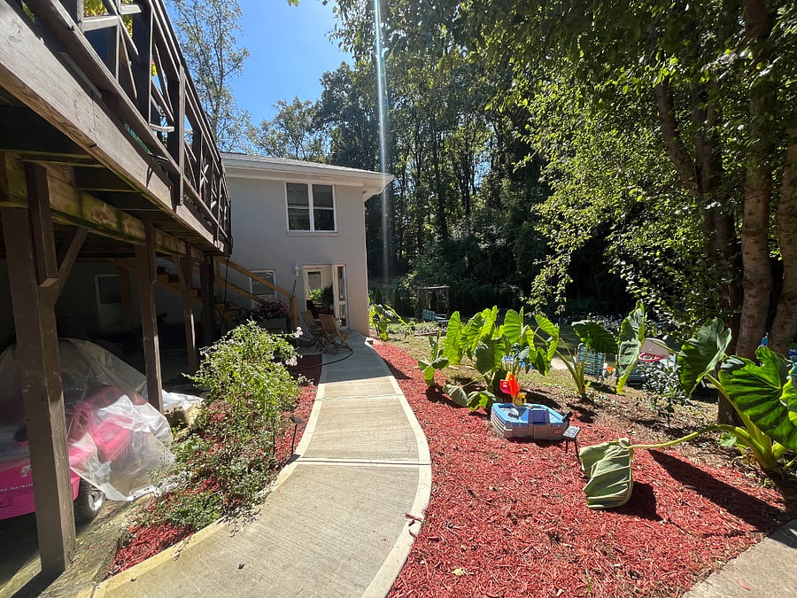 Pathway to the apartment from the parking spot on the driveway and garden. The plants will all come back in March.