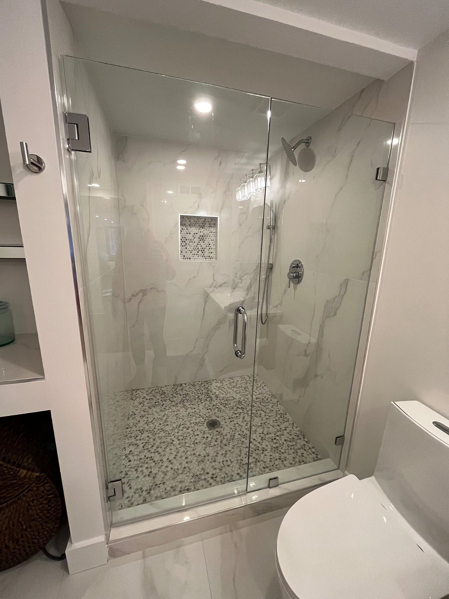 Large walk in shower with two shower heads.