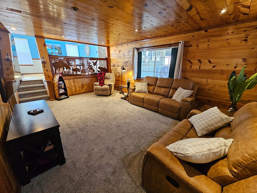 Comfortable reclining chair with bookshelf loaded with books.