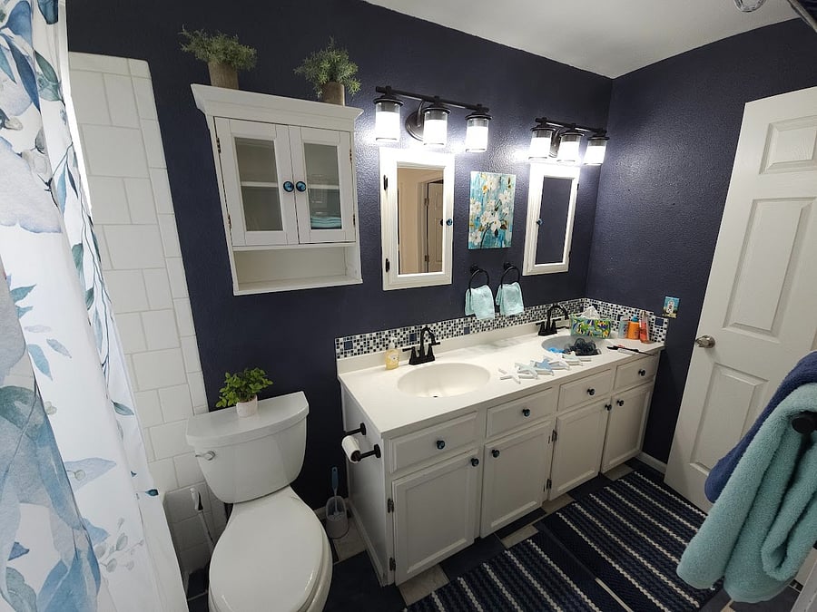 Full bathroom with access to master suite on upper level of house