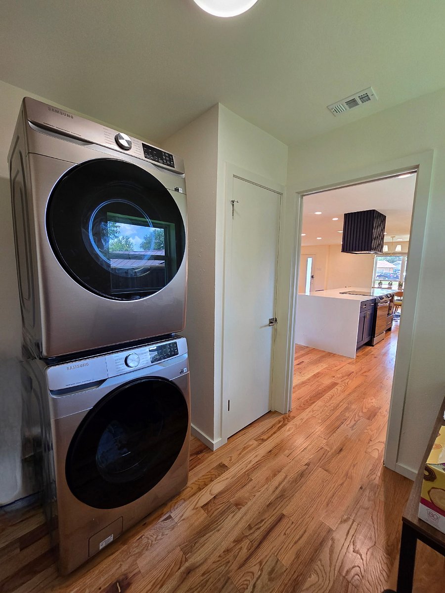Separate washer dryer room with folding table, automatic robot that mops and vacuums and pocket door to decrease sound.