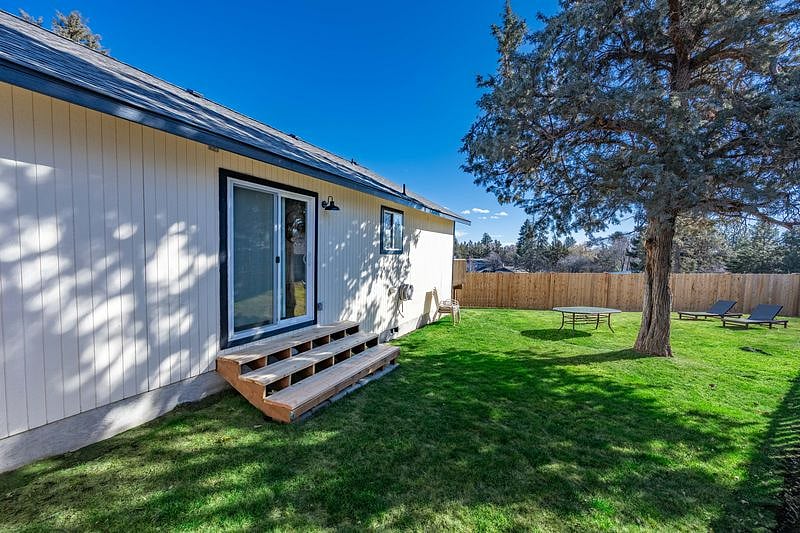 Sliding glass door and a few steps down to the fully fenced large side yard