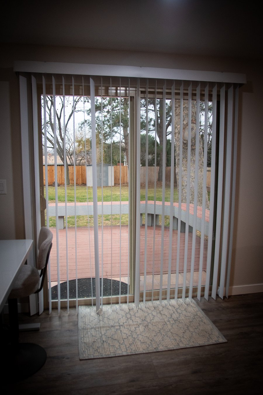 The patio door located in the fireside living room, offering beautiful views of the backyard