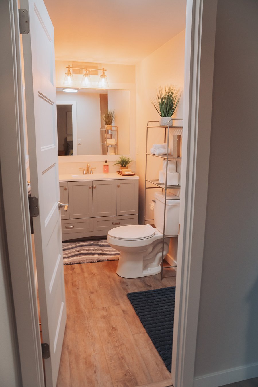 The private master bath: beautiful vanity, ample light, and a comfortable standing shower