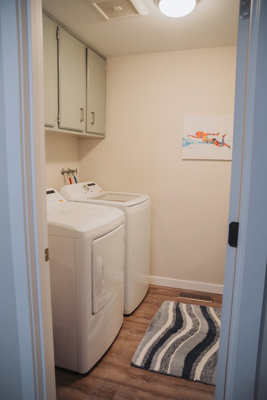 Across from the sliding door in the fireside living room is the laundry/bathroom.