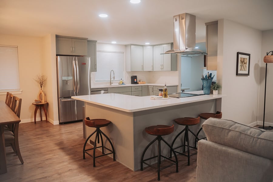 Beautiful and adjustable 4 person bar seating on the large kitchen prep space. Note the stainless steel full sized fridge, stove and dishwasher.