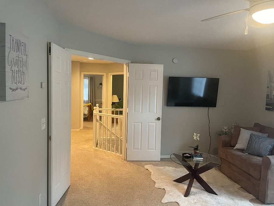 Big screen, smart TV.   French doors lead to hall and other bedrooms and bath.