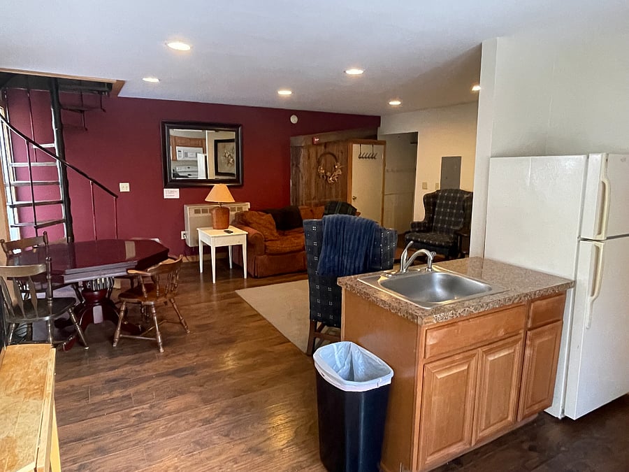 View of living space from kitchen near the entry door