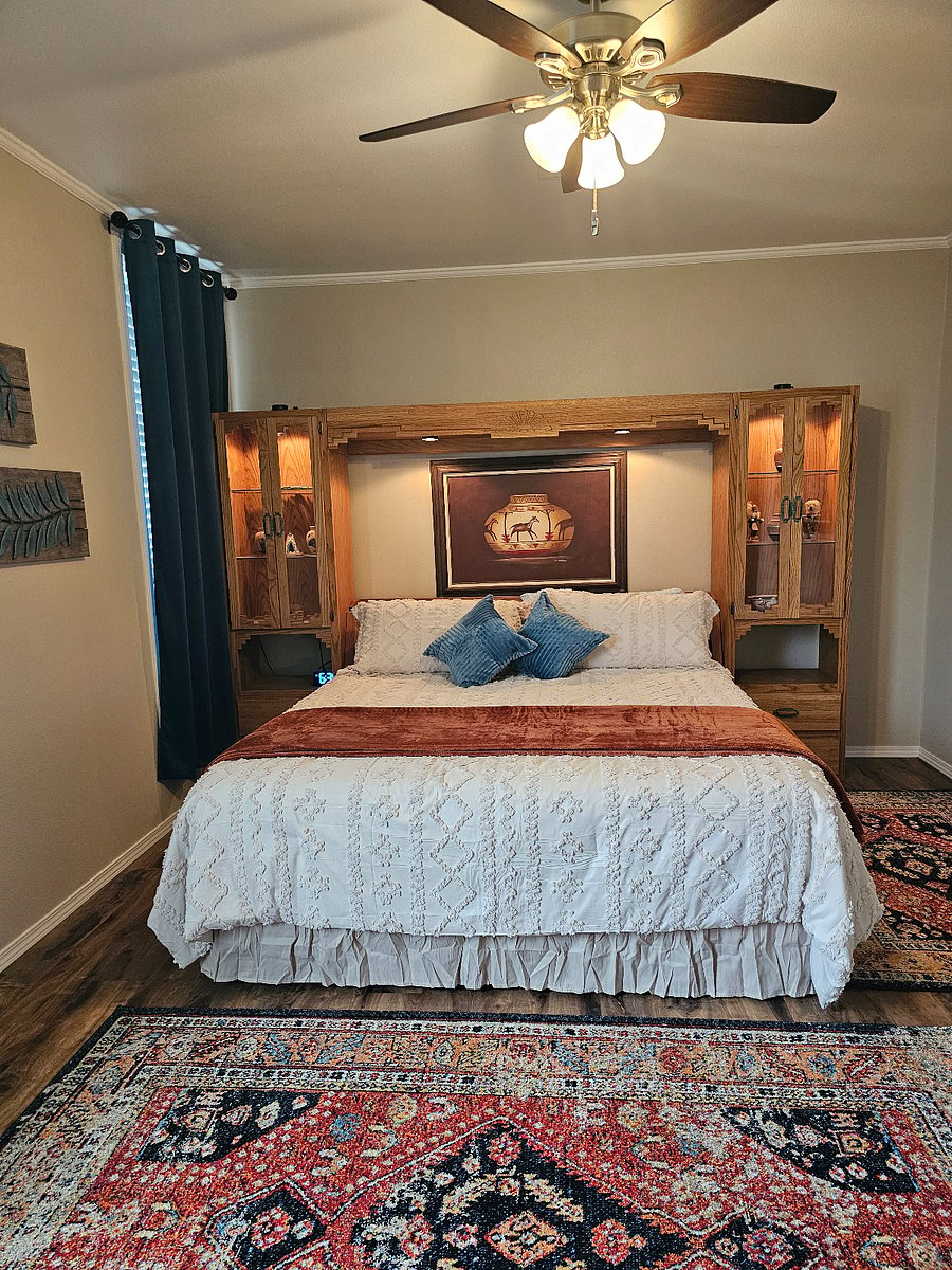 Primary bedroom with king bed TV and walk in closet offering a quiet and comfortable retreat.