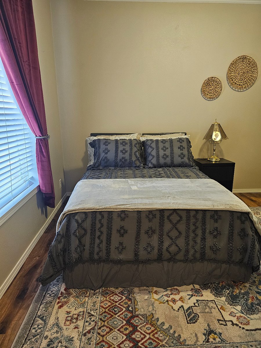 Comfortable guest bedroom featuring a full bed TV dresser and closet offering a quiet and private space to unwind.