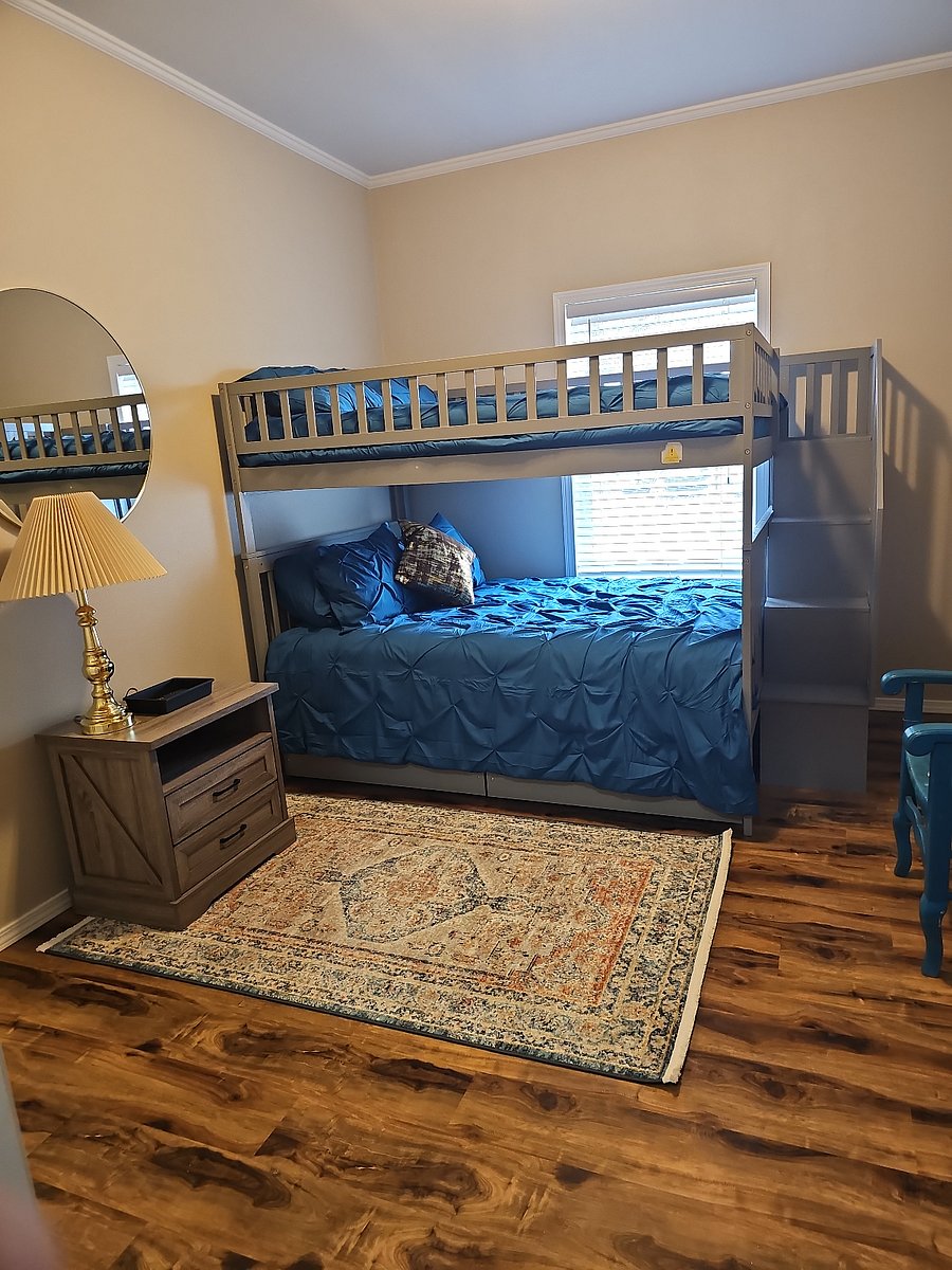 Spacious bunk room featuring a full over full bunk bed TV dresser and closet ideal for families or additional guests