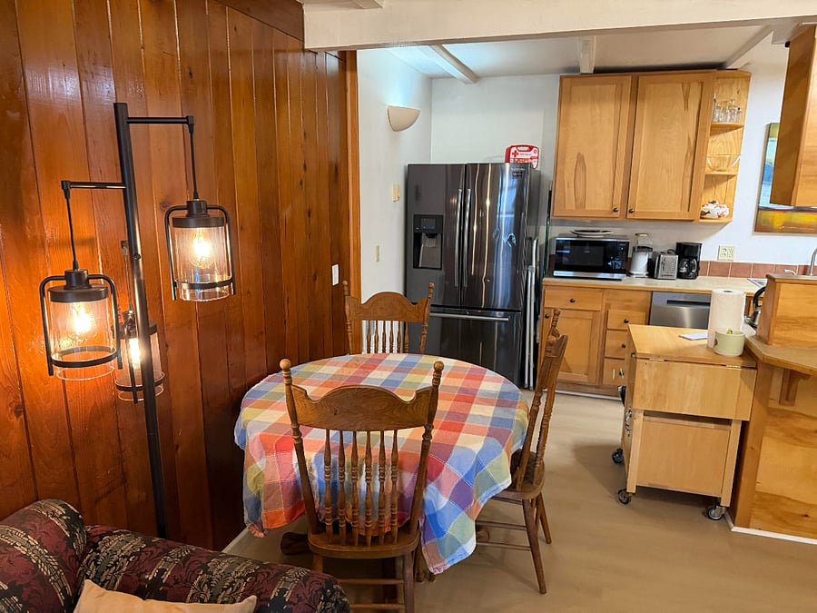a view of the dining table and kitchen