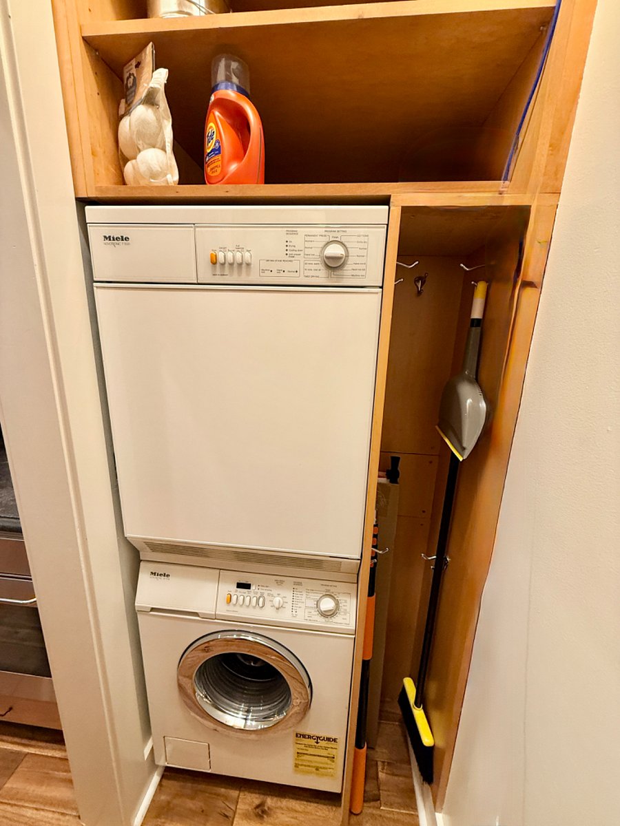 In unit washer and dryer in closet near kitchen