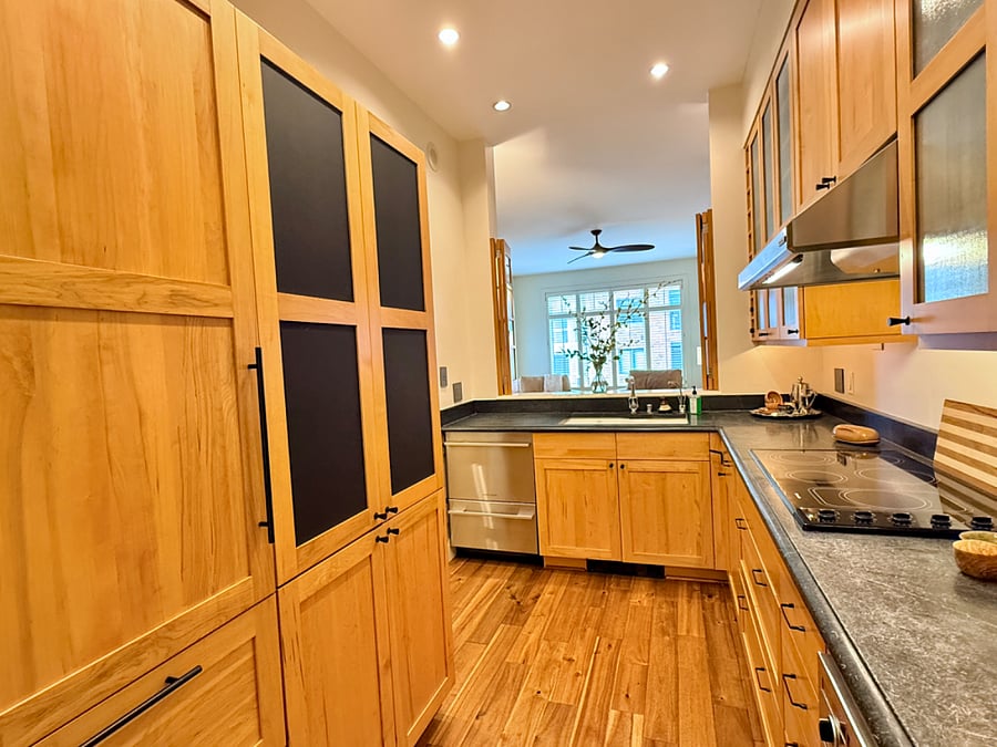 Full kitchen with pull-out shelving; premium GE, Miele, and Fisher & Paykel appliances; abundant cabinetry