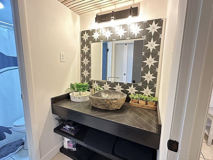 Downstairs bathroom with access from the hallway or main bedroom.