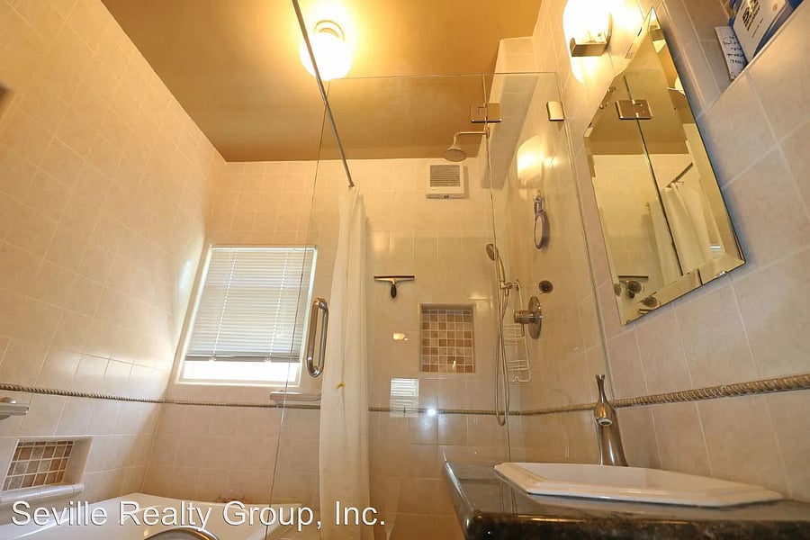 Shared bathroom with rain shower and tub