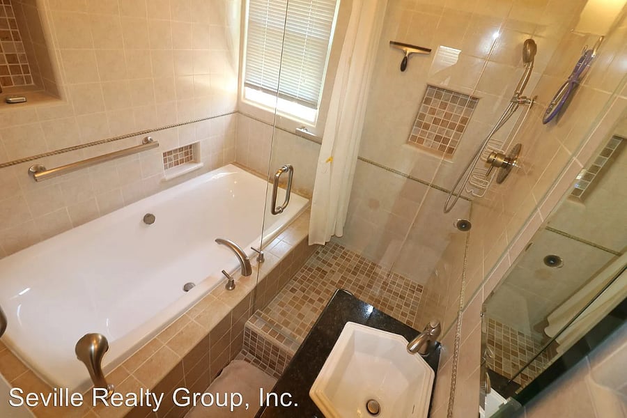 Shared bathroom with rain shower and tub