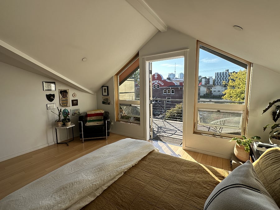 Primary bedroom with balcony and garden view