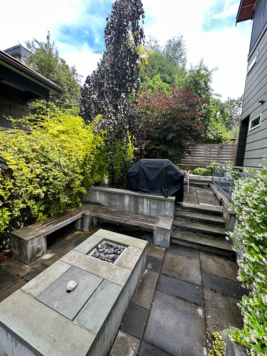 View of lower patio with grill and outdoor dining
