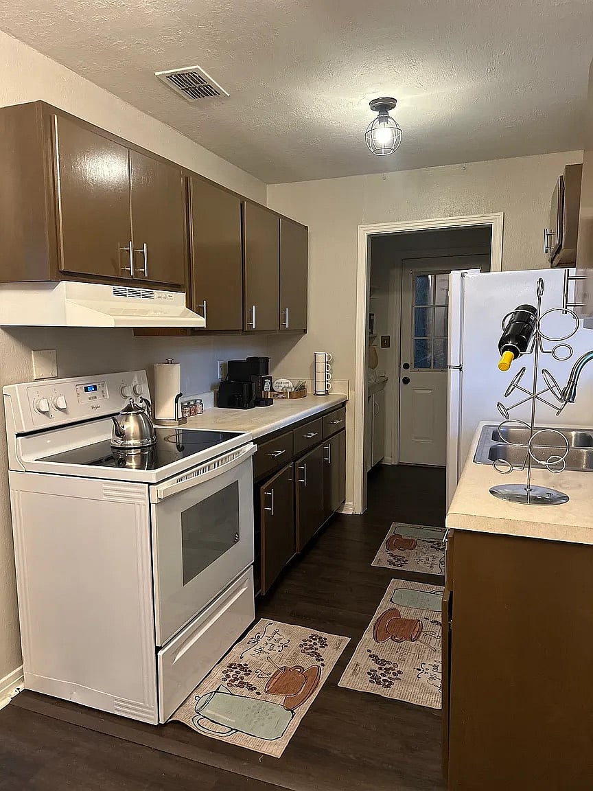 A fully equipped kitchen featuring full-size appliances, ample counter space, and all the cooking essentials you need to prepare home-cooked meals. Includes a convenient microwave and electric range to make meal prep easy between shifts.