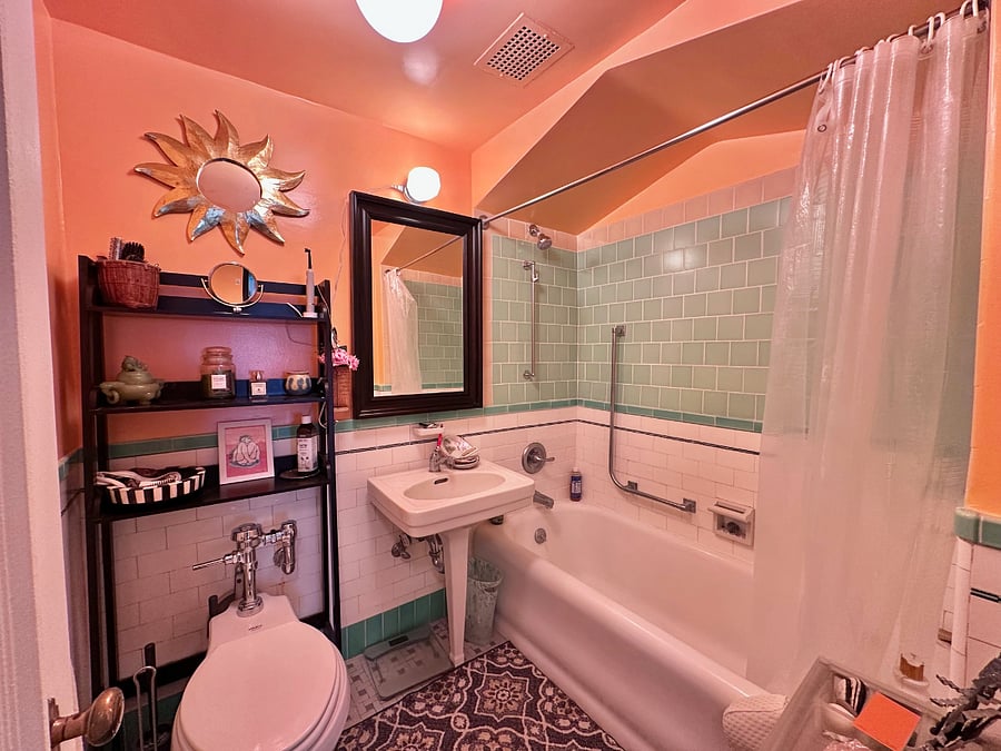 Shower/tub with hand rails.