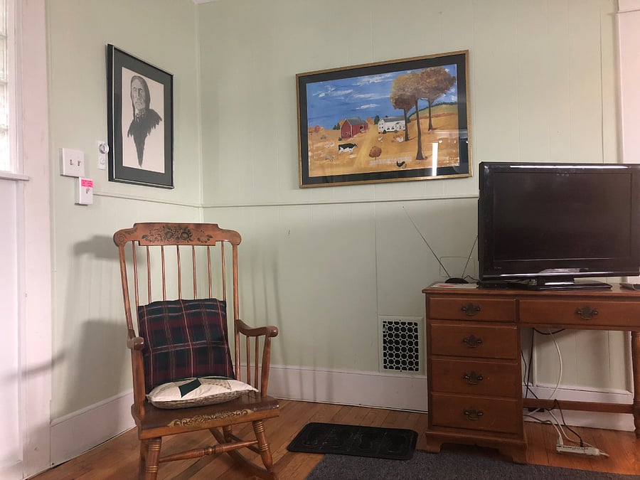 The large living room has plenty of seating with 2 sofas and a rocking chair