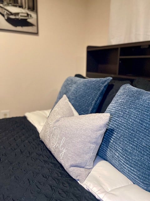 Cozy Grey Room with 4 comfy pillows, smart TV, study desk, remote fan, blackout curtains, and a private hallway restroom. Everything you need for a restful stay.