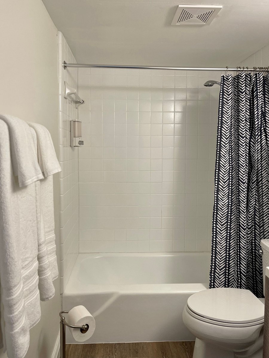 Immaculate bathroom with bath sheets, towels, and hair dryer provided