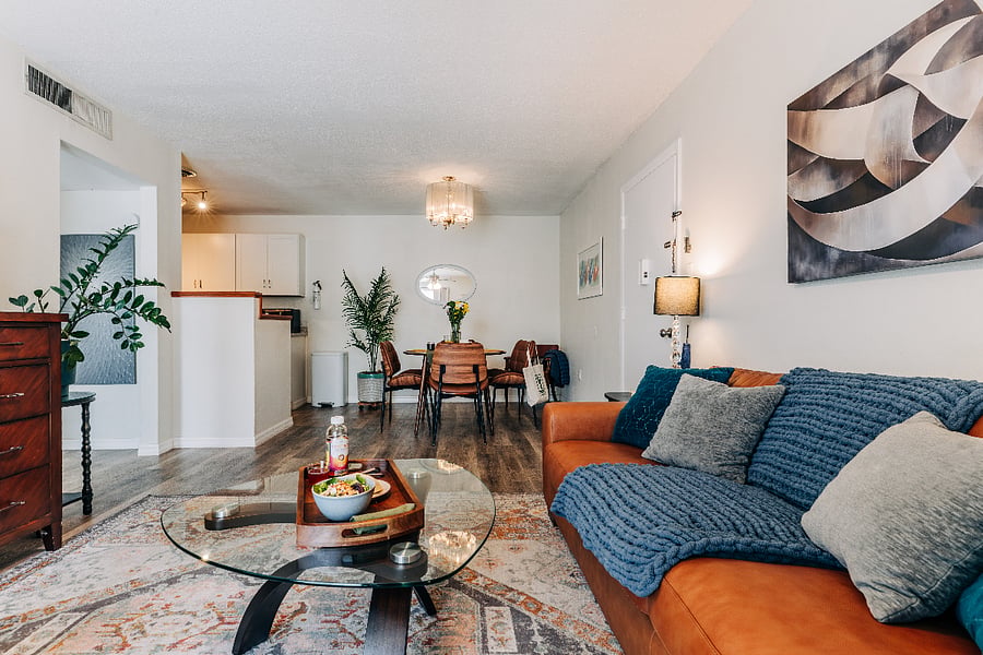 Living room with table, ottoman, throw blankets, and dedicated workspace so you can be comfortable and productive.