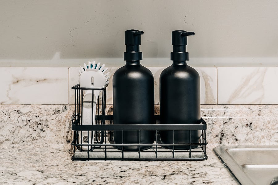 Dish soap and hand soap dispenser with quick-drying diatomaceous earth tray.