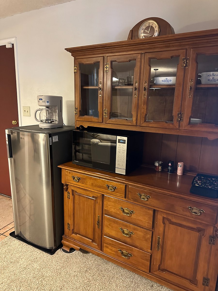 Kitchenette includes brand new fridge, microwave, 10 in 1 toaster oven/air fryer, coffeemaker & tableware.
