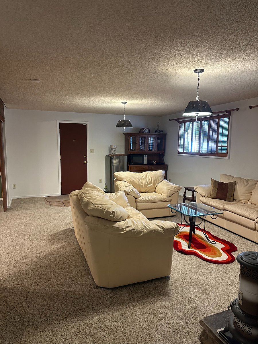 Open concept living area includes fireplace, TV, pool table and card table.