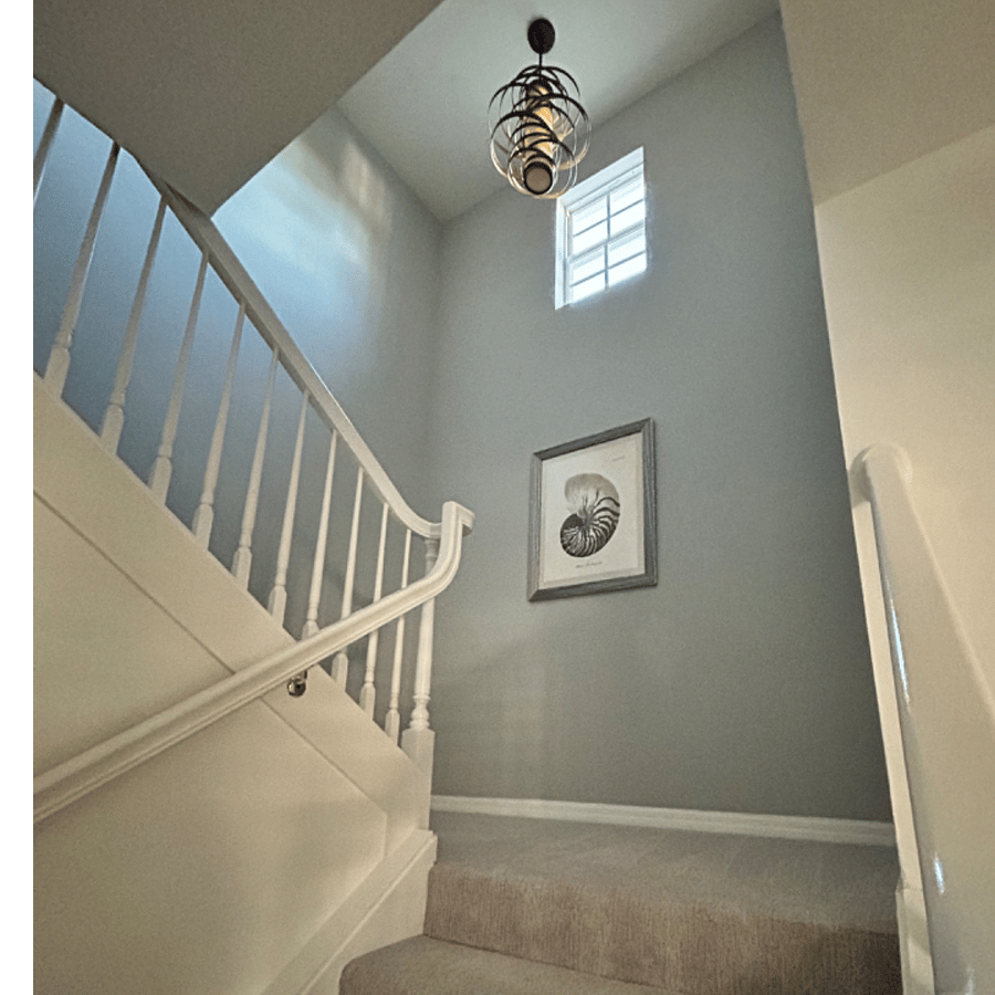 Grand staircase with dramatic cathedral ceiling