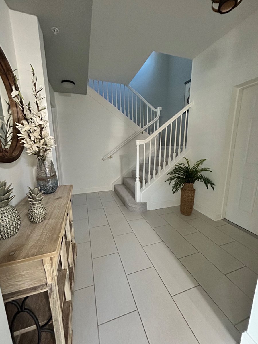 Large welcoming foyer with laundry room just off the entry