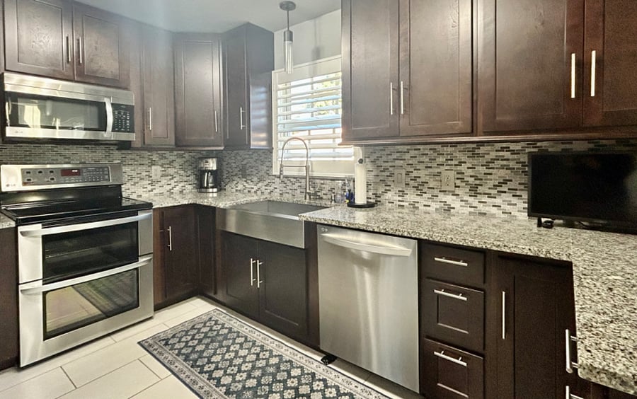 Well-appointed kitchen w/granite counters, stainless appliances, rich cabinetry