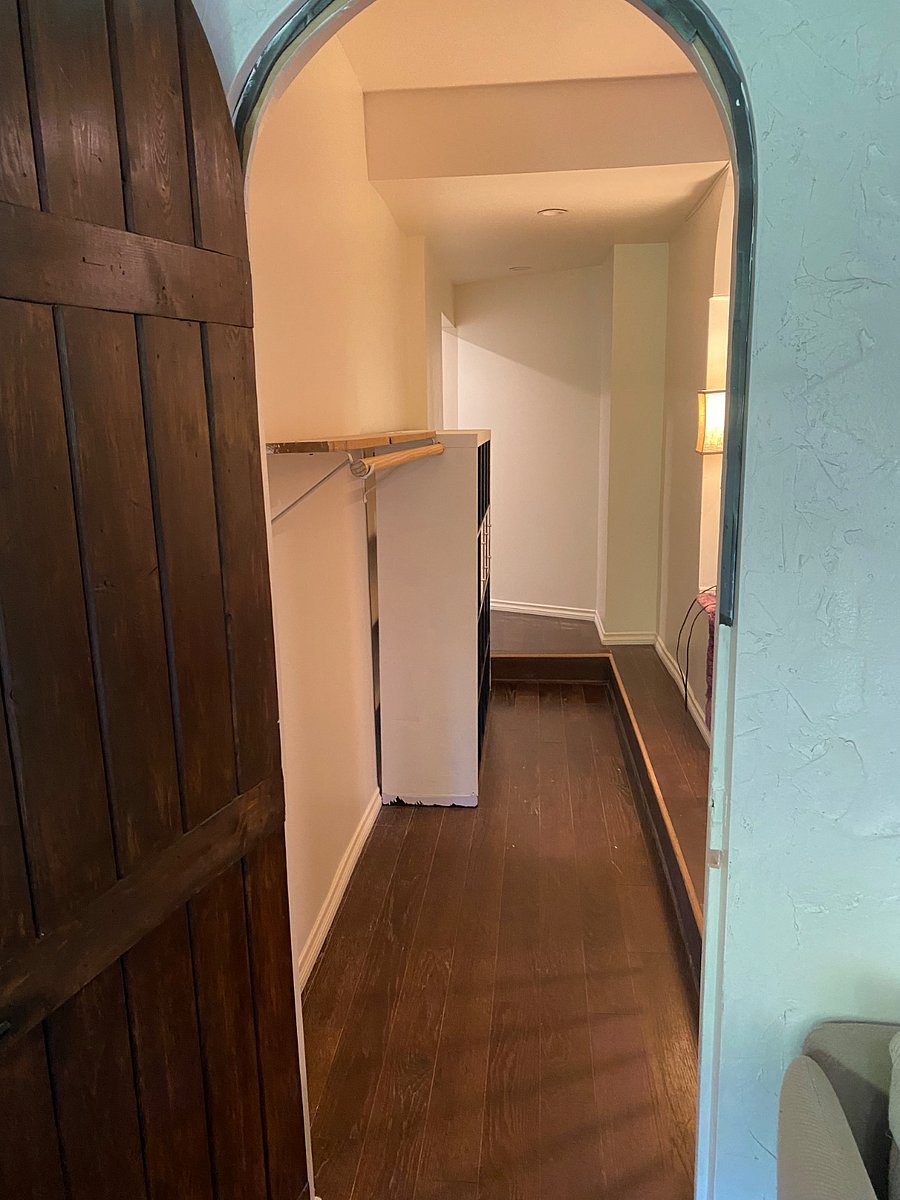 Walk in closet and walkway to bathroom.