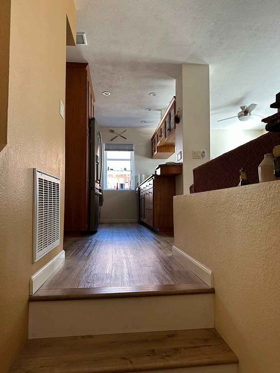 Stair to upper level with living area and Primary Bed and Bath