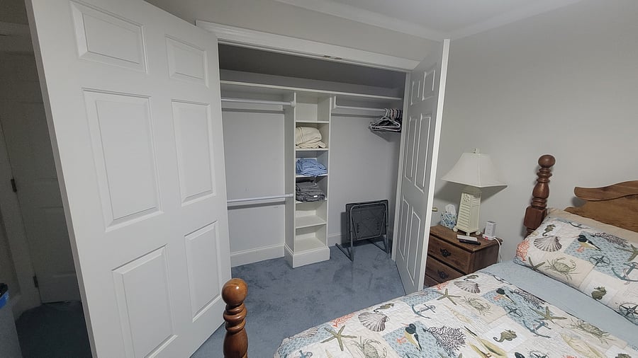 Spacious closet with linens, blanket and portable desk.